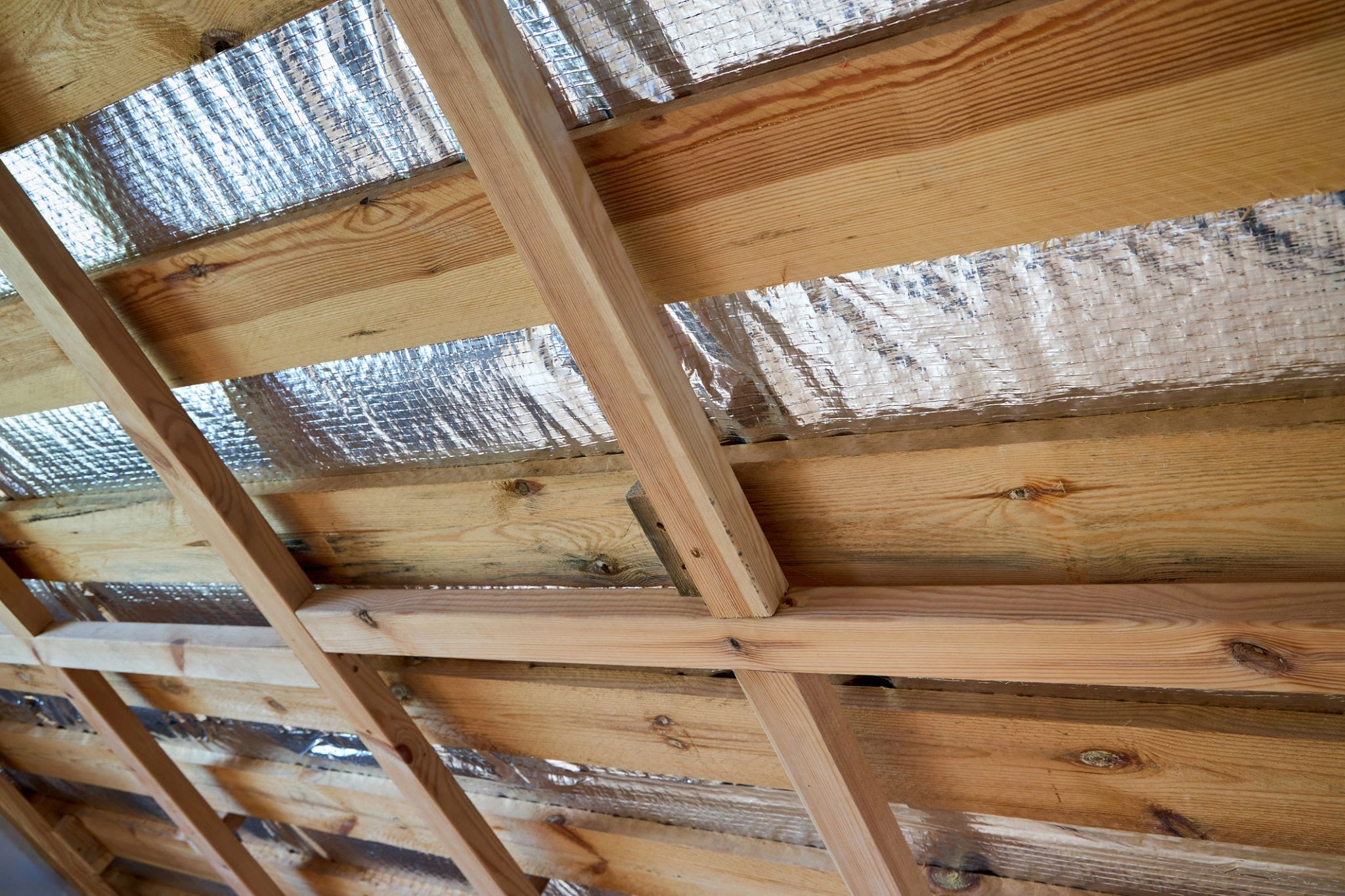Thermal insulation diagram showing radiant heat reflected away from a building